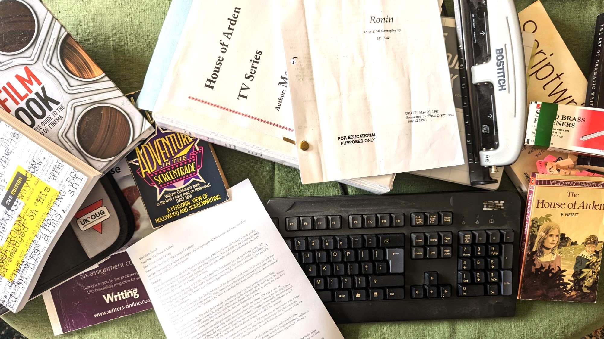 scattered books and scripts  for a screenwriter as well as an IBM keyboard